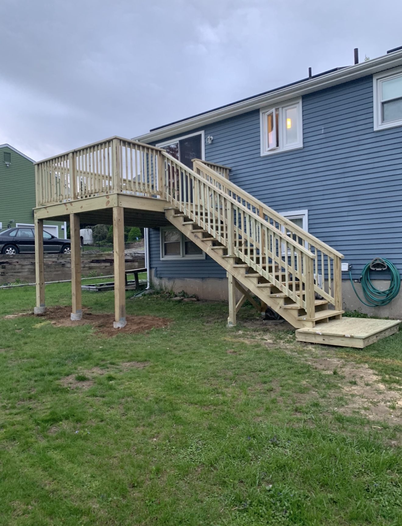 Newly built elevated wood deck and staircase on the back of a Connecticut home, showcasing Next Gen Construction craftsmanship